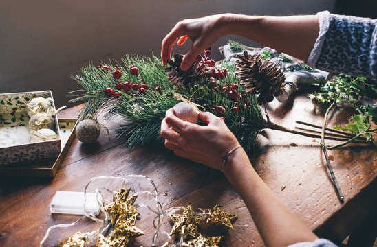 Woman prepares Christmas decorations.