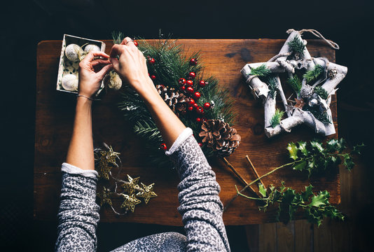 Woman prepares Christmas decorations.