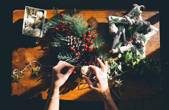 Woman prepares Christmas decorations.
