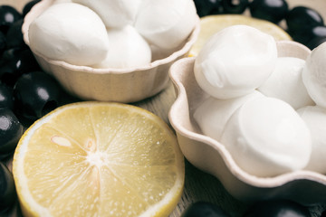 Black olives, mozzarella cheese and lemon slices close-up