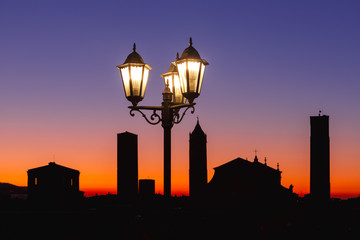 Night aerial view of Bologna Cathedral and towers of Old Town in medieval city Bologna with vintage beautiful lantern at sunset, Emilia-Romagna, Italy