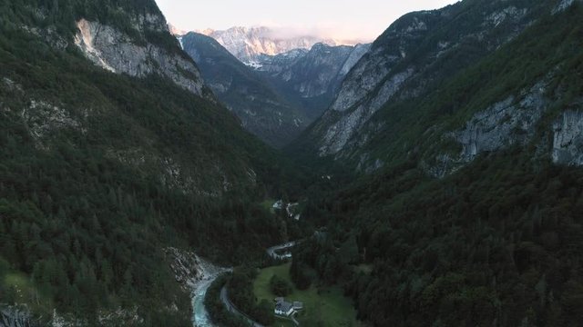 Aerial view above Trenta Valley looking up the canyon towards the Julian Alps, viewing the river winding below.