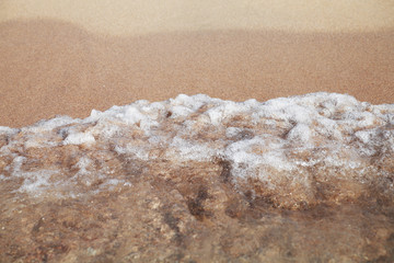 Fototapeta na wymiar Stormy sea background.Waves and splashes.Sandy beach.