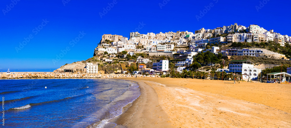 Wall mural italian holidays - picturesque peschici with wide sandy beach in puglia.