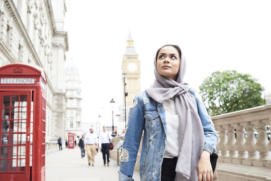 UK, England, London, young woman wearing hijab walking in the city - Powered by Adobe