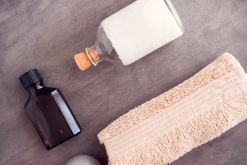 Obraz premium SPA beauty products still life. Body and skincare massaging oil, serum, cream and towel from above. Luxury salon concept