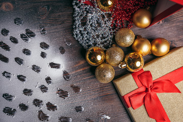 Christmas decorations, golden balls, footprints in the snow