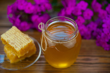 Delicious delicious honey in  jar on table