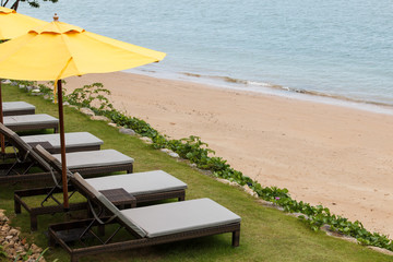 Outdoor beach chairs and yellow umbrellas
