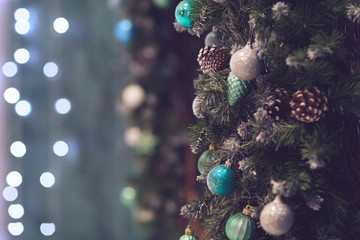 Christmas decoration with lights on the turquoise background. Free space for the text.