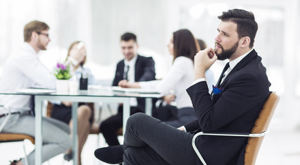  Manager of the company on the background of the working meeting the business team