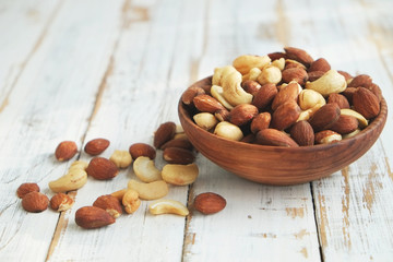 Assorted nuts in wooden bowl.