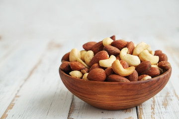 Assorted nuts in wooden bowl.