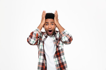 Portrait of a shocked astonished young african man