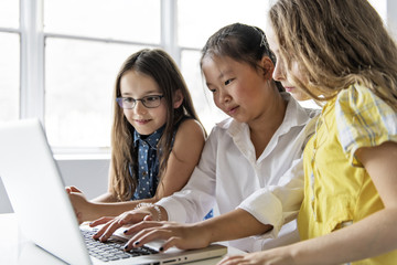 Group of curious children watching stuff on the laptop screen