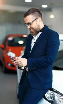 Man Using Phone In Car Dealership.