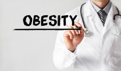 Doctor writing word OBESITY with marker, Medical concept