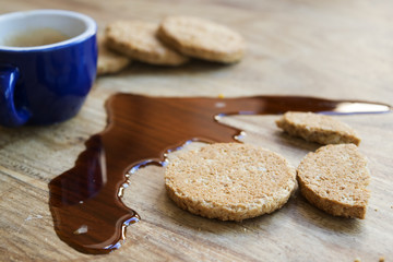 biscuits and espresso coffee spilled on the table