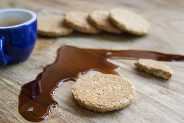 biscuits and espresso coffee spilled on the table