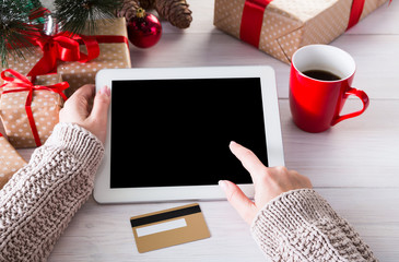 Woman shopping online with a credit card, top view