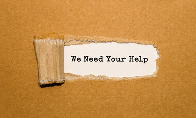 The text We Need Your Help appearing behind torn brown paper