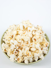 Butter popcorn in the green ceramic bowl.