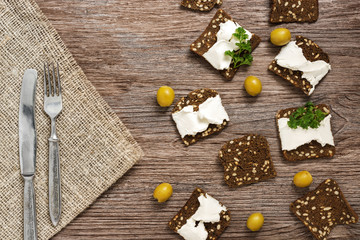 Rye croutons with cheese. Canape with cheese and olives.