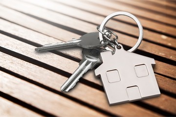 House keys with house figure  on background