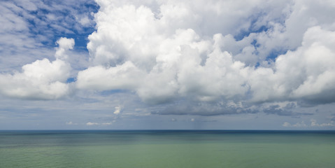Obraz premium Stylized abstract landscape seascape sunset long exposure with clouds under different shades of blue, orange, yellow and red.