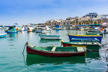 Fototapeta na wymiar Traditional boats at Marsaxlokk Harbor in Malta