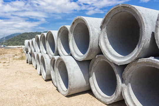 Precast concrete manholes are stored on the ground ready for construction