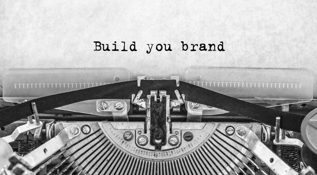Build you brand words typed on a vintage typewriter in black and white.