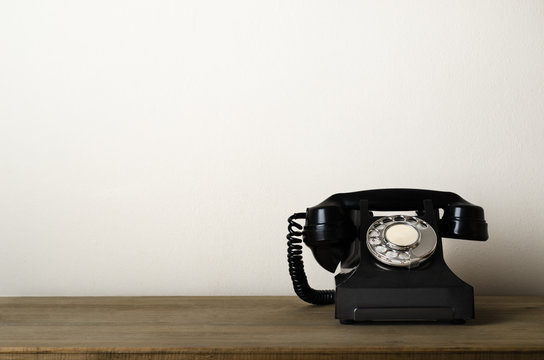 Vintage Black Antique Telephone on Wooden Desk