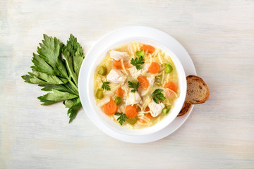 Chicken soup with noodles, overhead photo with copyspace
