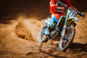 Close-up part of mountain bikes race in dirt track in sunshine day time. Concept focus of during an...