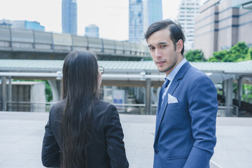 Fototapeta premium Professional businesswoman and businessman standing outdoors in cityscape background