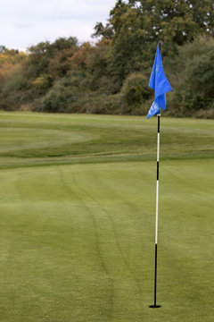 Blue golf flag on tee