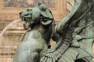 Fototapeta na wymiar Statue of the bronze winged dragon, part of the monumental marble (26 meters by 15 meters) fountain Saint-Michel opened in 1860 during the French Second Empire, Paris, France
