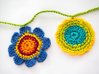 Two Multi-Colored Crocheted Flowers on a Garland Chain