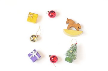 Christmas decoration/ Yellow and purple gift boxes, golden and red balls, toy wooden horse and Christmas tree. Happy New Year flat lay greeting card. Mockup