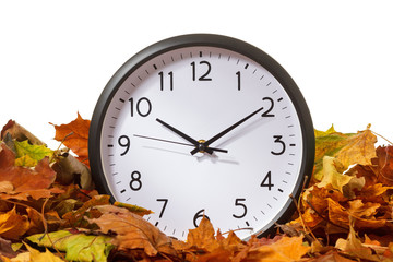 Clock in autumn leaves, isolate on white background
