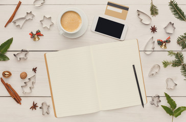 Smartphone and cookie cutters on white wooden table, top view