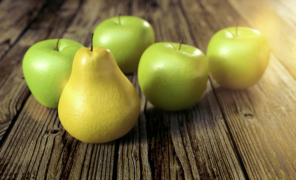 eine gelbe Birne unter grünen Äpfel