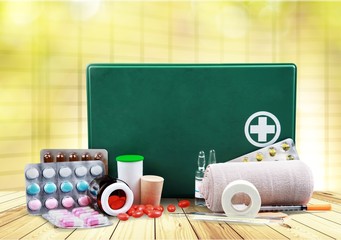 First aid kit  with medical supplies on light background