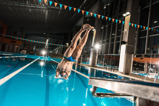 swimmer diving in swimming pool