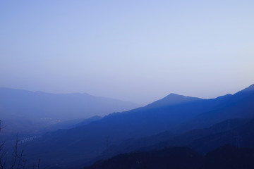 A view from mountains to the valley covered with smog.