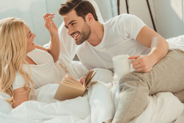 couple drinking coffee in bed