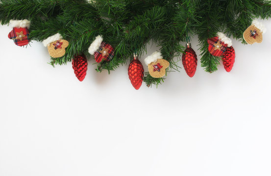 Christmas Spruce With Decoration Made Of Mittens And Red Cones