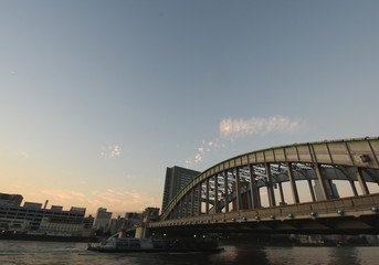 Fototapeta na wymiar 日本の東京都市風景・夕暮れ「墨田川などを望む」（右は、勝鬨橋）