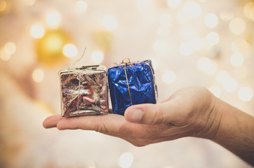 Christmas concept. hand holding gift box on bokeh background